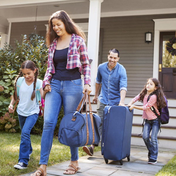 Family leaving house with luggage